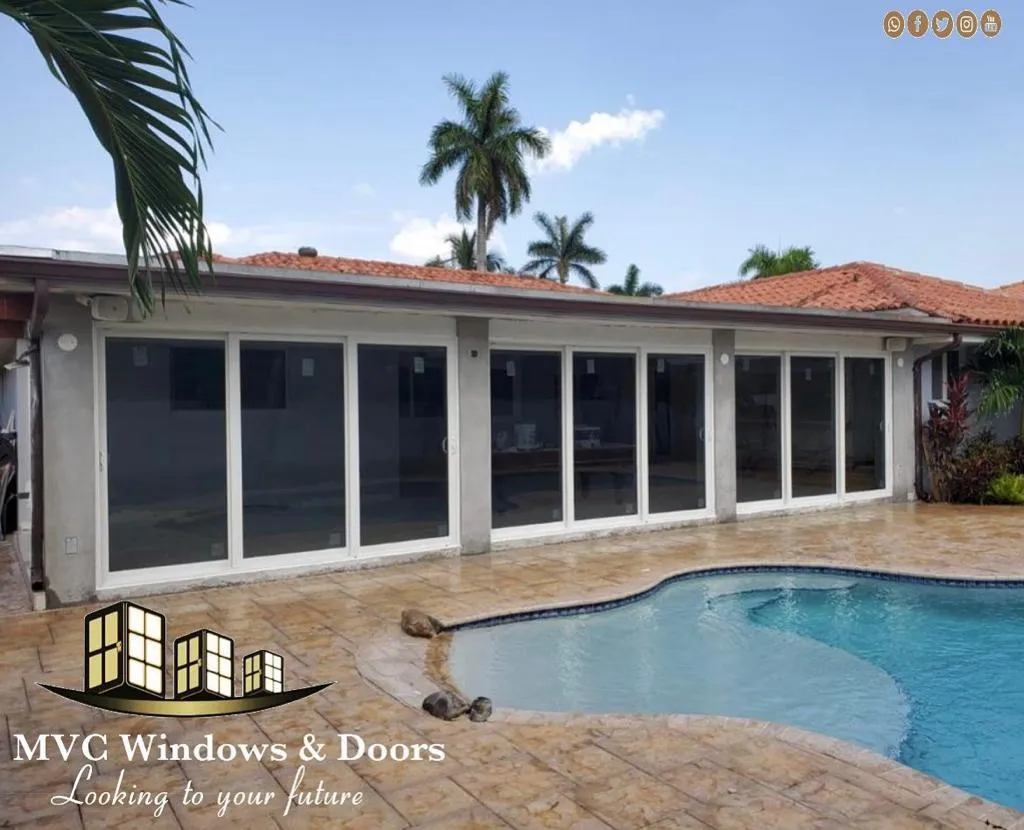 Impact sliding glass door running on a bottom track
